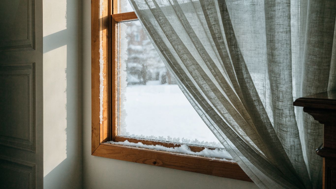 Cold winter light and frost beside a window frame